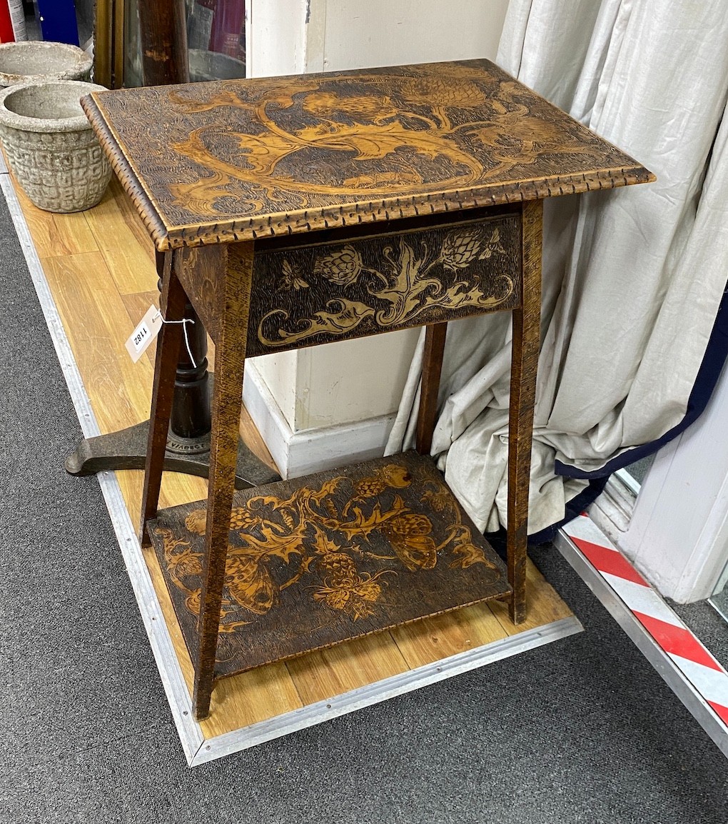 An early 20th century poker work two tiered occasional table, width 50cm, depth 34cm, height 70cm